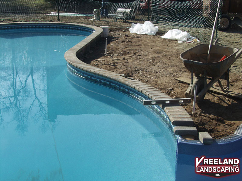 Towaco, NJ, Bull nose paver brick coping being installed on existing pool 